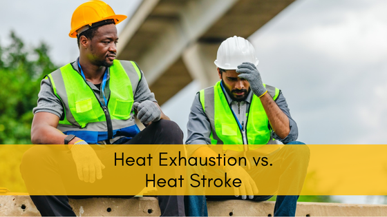 Construction worker in a yellow hard hat checking on a coworker who holds his head with signs of heat exhaustion